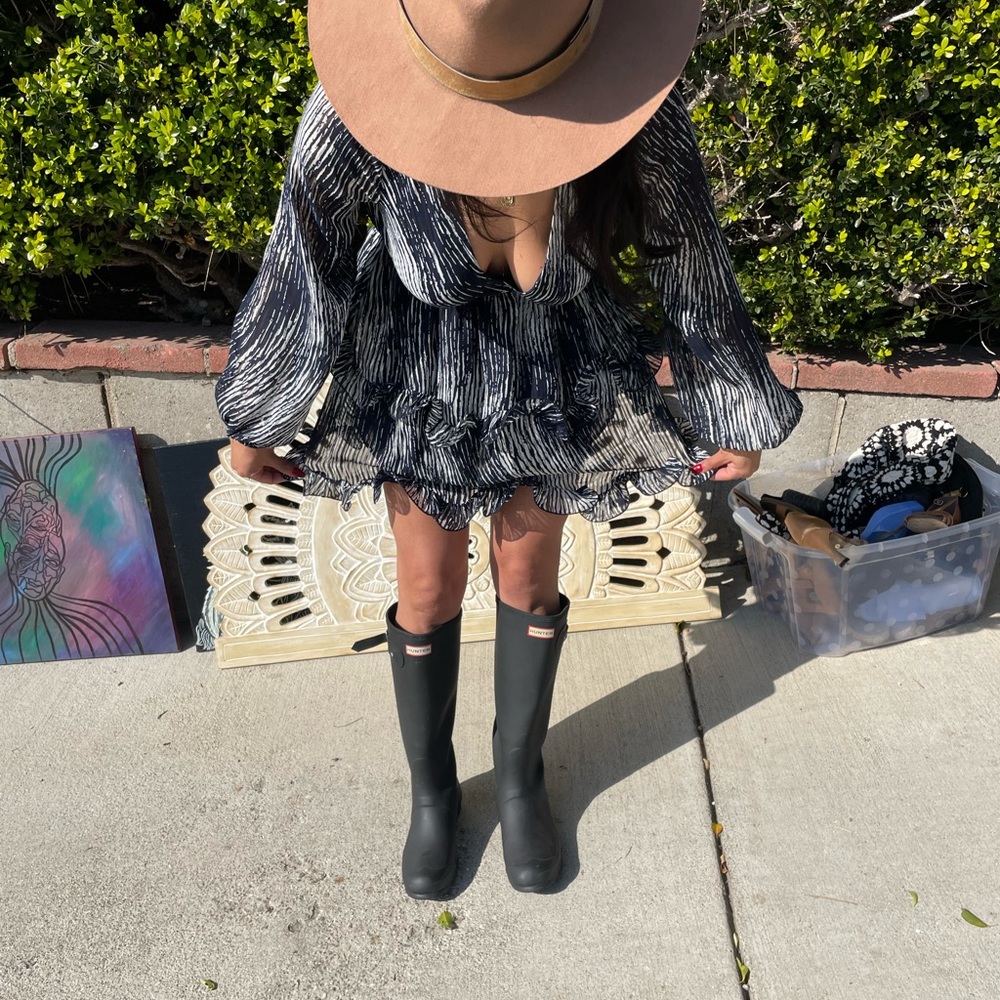 Hunter tall rain boots.